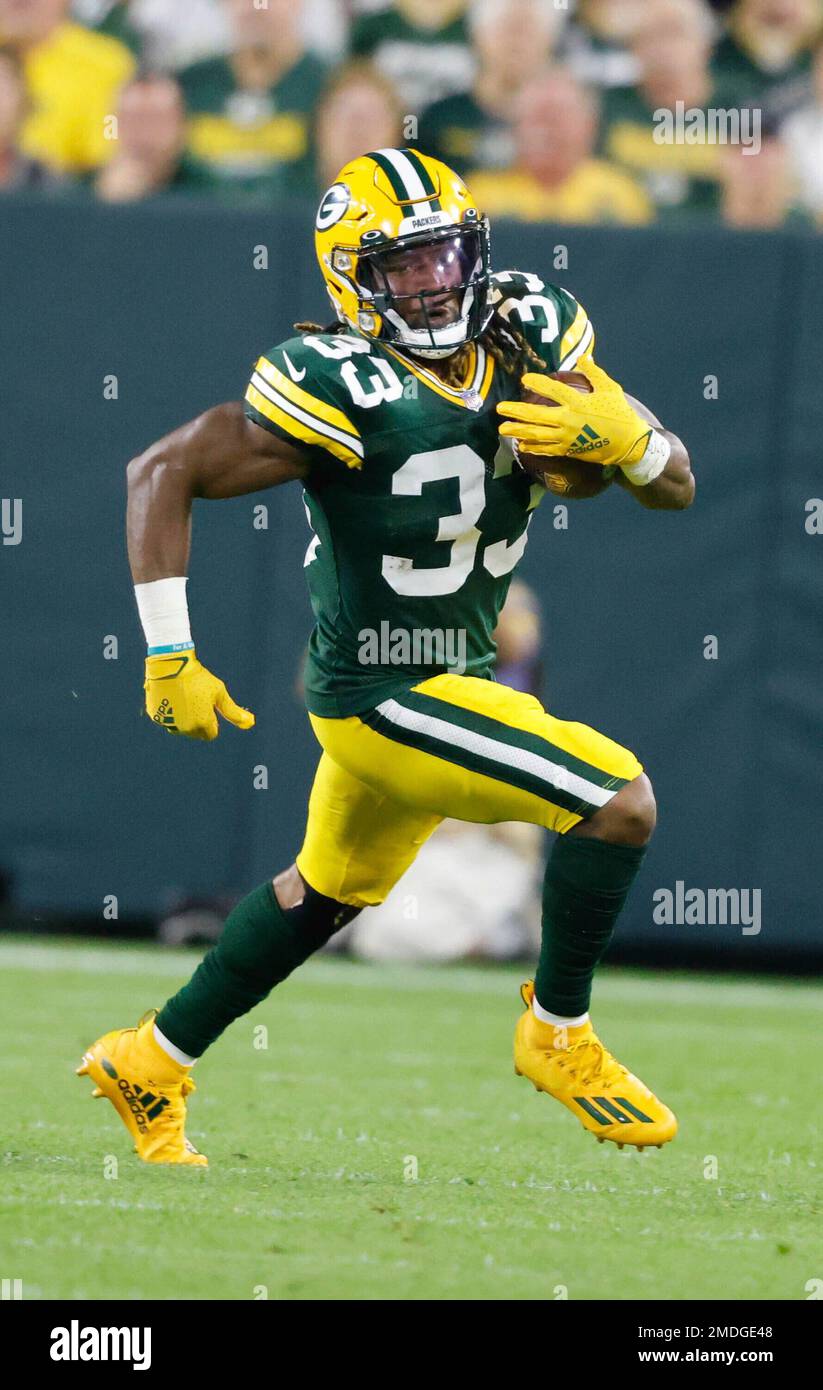 Green Bay, Wisconsin, USA. 02nd Jan, 2022. Green Bay Packers running back  Aaron Jones #33 runs the football during NFL football game between the  Minnesota Vikings and the Green Bay Packers at