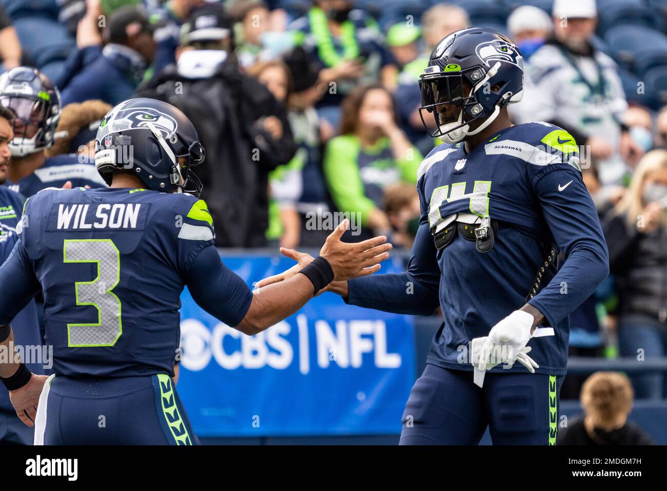 Seattle Seahawks quarterback Russell Wilson (3) greets wide receiver DK  Metcalf (14) during warmups before an NFL football game against the Tennessee  Titans, Sunday, Sept. 19, 2021, in Seattle. (AP Photo/John Froschauer