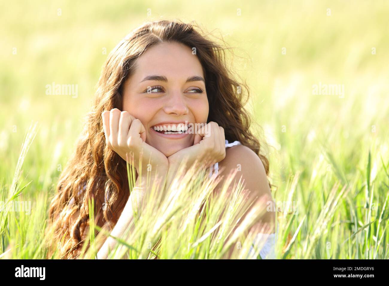 Candid happy woman smiling in a wheat field Stock Photo