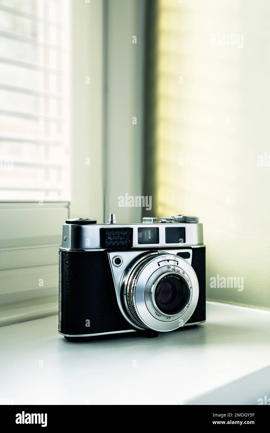 35mm film camera on a windowsill. Stock Photo