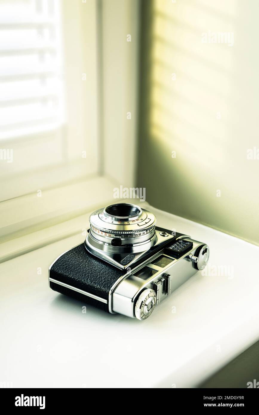 35mm film camera on a windowsill. Stock Photo
