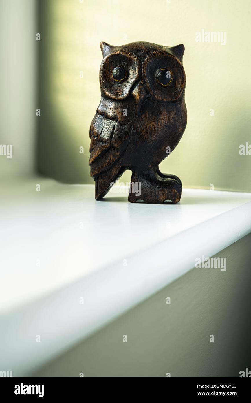 Wooden ornament owl on a windowsill. Stock Photo