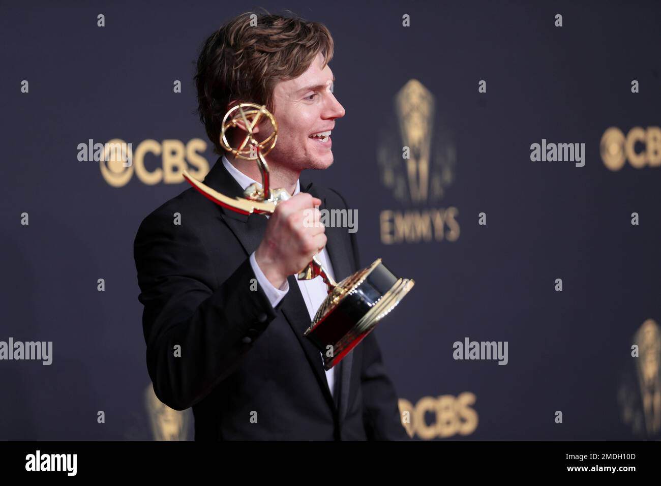 Evan Peters poses for a photo with the award for outstanding supporting