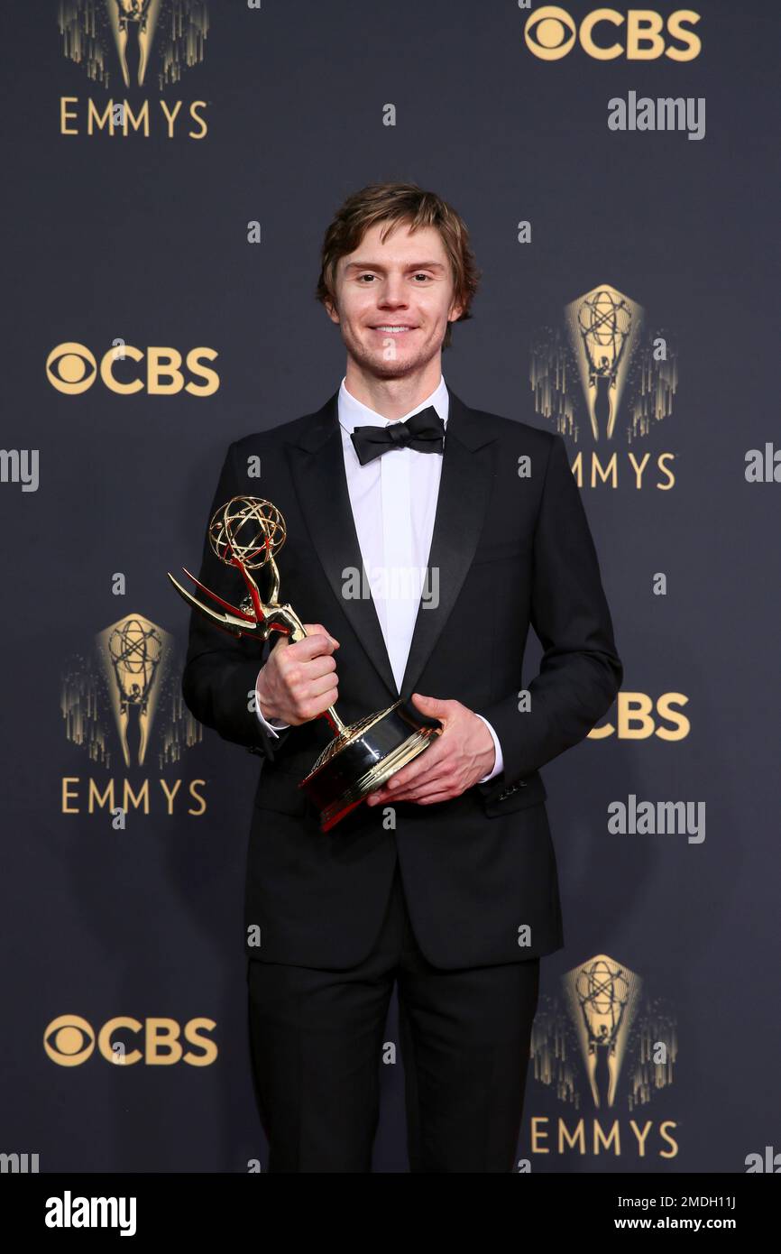 Evan Peters poses for a photo with the award for outstanding supporting