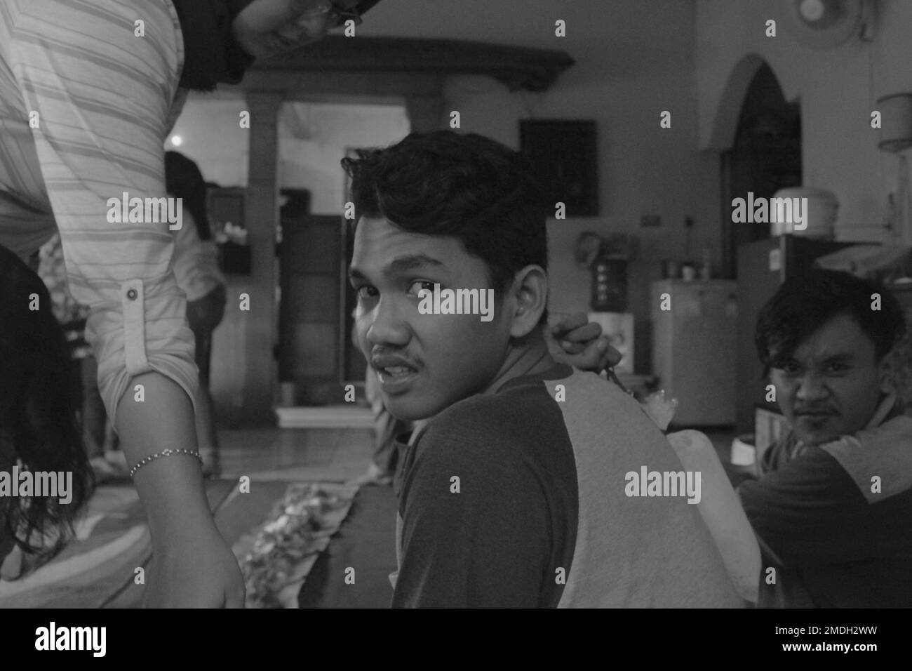 Jakarta, Indonesia - 02 24 2020: black and white photo of strange facial expressions of a boy hanging out with his friends Stock Photo