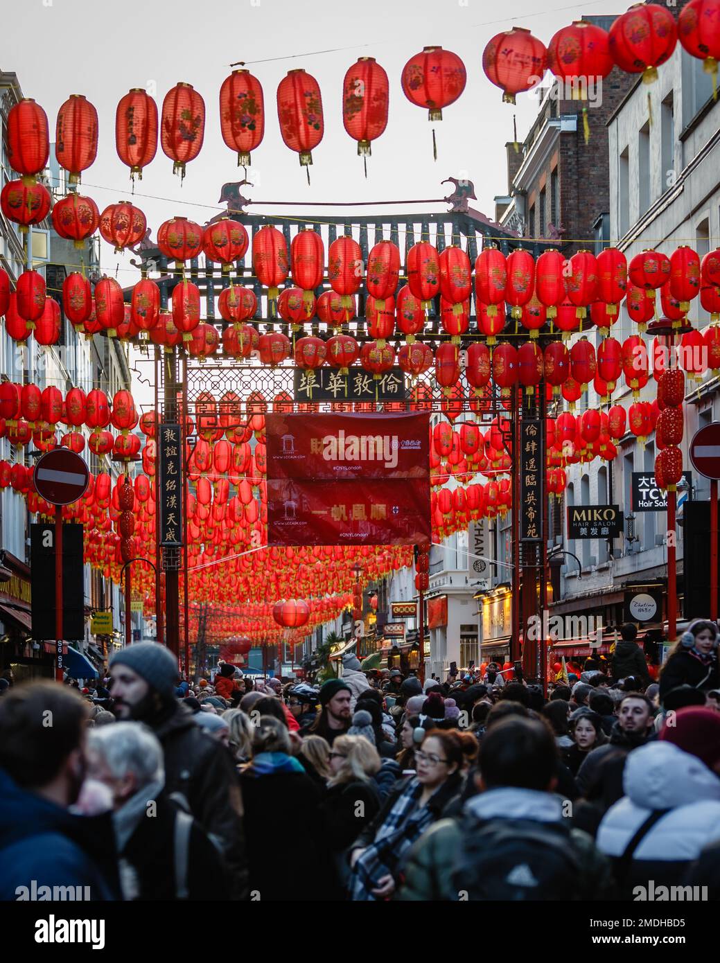 Red lanterns hanging over London's busy Chinatown during the lunar new year celebration. Stock Photo
