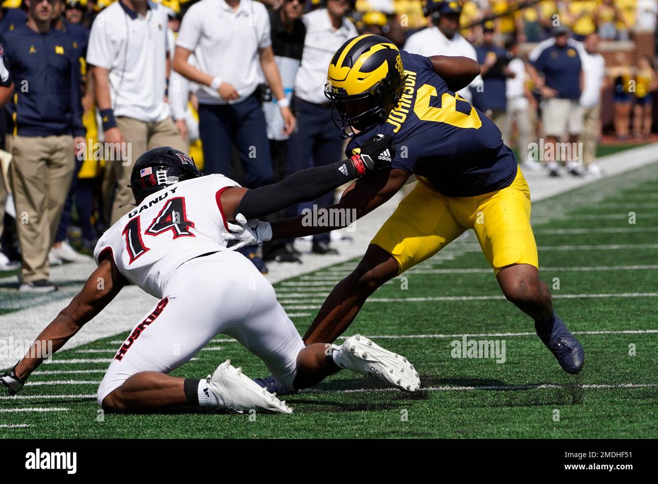 Michigan wide receiver Cornelius Johnson (6) breaks the tackle of