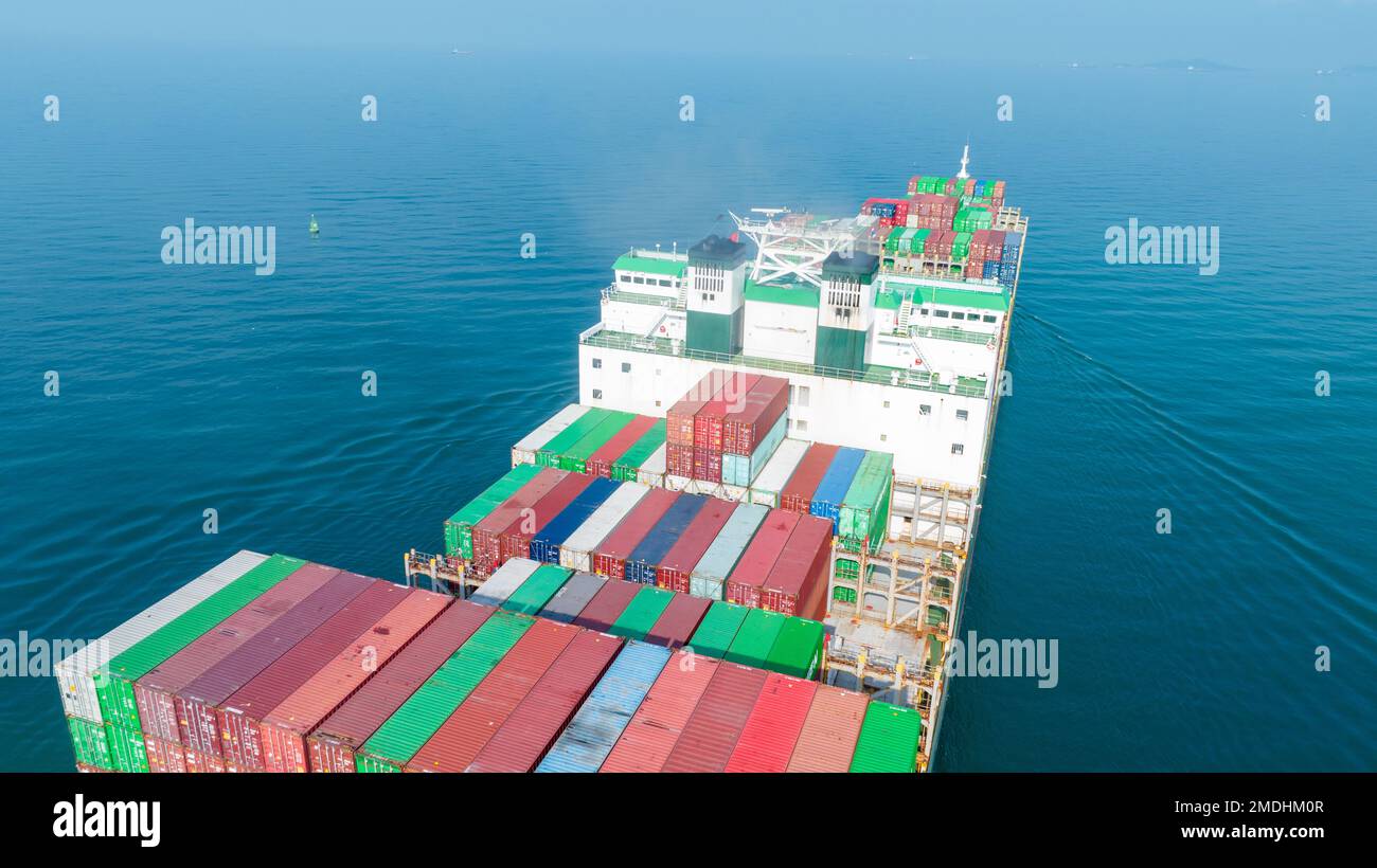 Cargo container Ship, cargo maritime ship with contrail in the ocean ship carrying container and running for export concept technology freight shippin Stock Photo