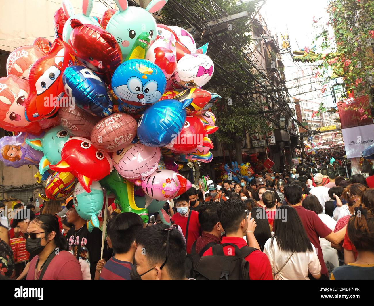 Manila, Philippines. 22nd Jan, 2023. People walk along Ongpin street during the celebration. After two year absence because of the COVID-19 pandemic, Chinese-Filipinos community, The pure Filipinos in the country as well as foreigners touring the country can now both enjoy the festivities of the Lunar New year here in Binondo or Manila's Chinatown in the Philippines. Credit: SOPA Images Limited/Alamy Live News Stock Photo