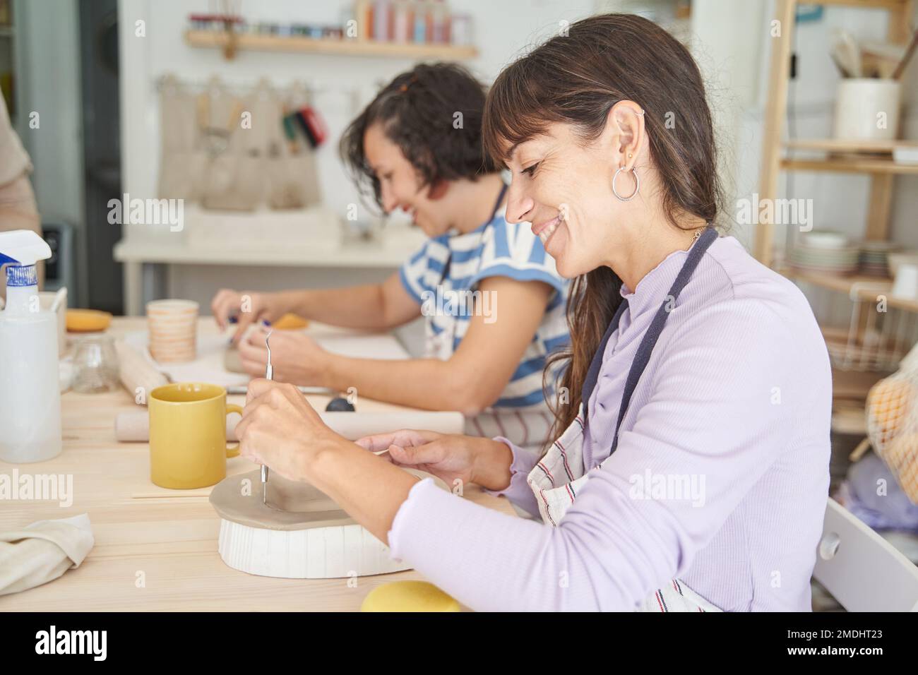 Women making handmade pottery in a pottery class. Handicraft and