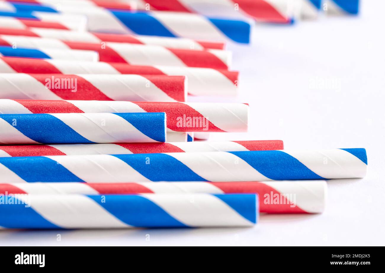 Multi-colored paper straws for drinks close-up on a white background. Stock Photo