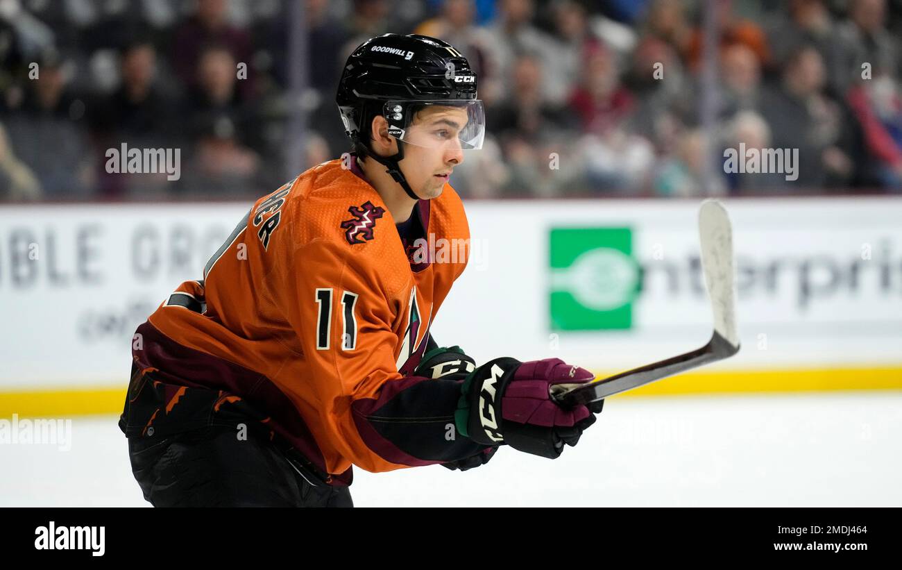 Arizona Coyotes right wing Dylan Guenther (11) and Vegas Golden Knights  right wing Reilly Smith (19) battle for position during the second period  of an NHL hockey game in Tempe, Ariz., Sunday