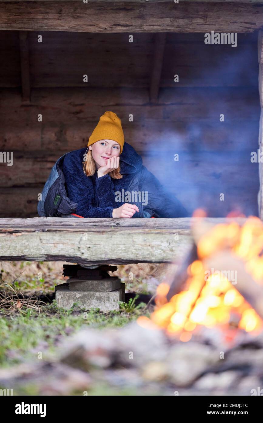 Young woman camping outdoors in nature Stock Photo