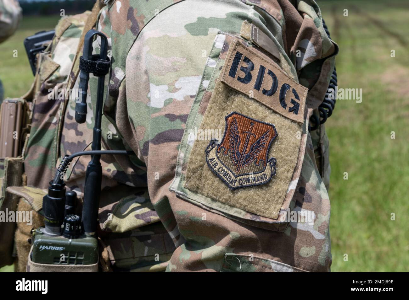 A U.S. Air Force Airman wears a Base Defense Group patch while defending an airfield during exercise Agile Flag 22-2 at Avon Park, Florida, July 24, 2022. Base Defense Group Airmen, assigned under the 93rd Air Ground Operations Wing, provided base and airfield security to ensure a safe forward operating station. Agile Flag 22-2 is Air Combat Command's first lead-wing certification event designed to demonstrate the 23rd Wing's capability to generate combat air power while continuing to move, maneuver, and sustain the Wing and subordinate force elements in a dynamic and contested environment. Stock Photo