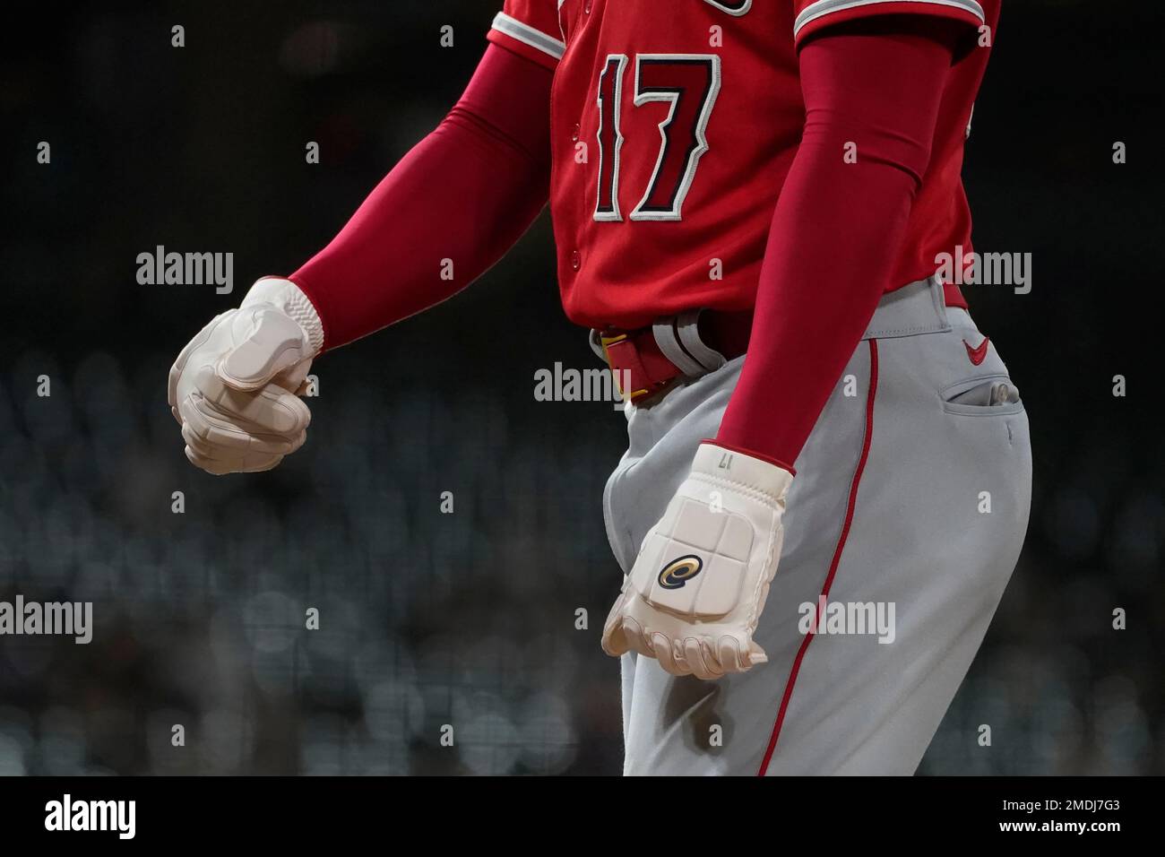 Los Angeles Angels' Shohei Ohtani wears thick protective gloves as he  occupies first base after drawing a walk during the fifth inning of a  baseball game against the Chicago White Sox Tuesday