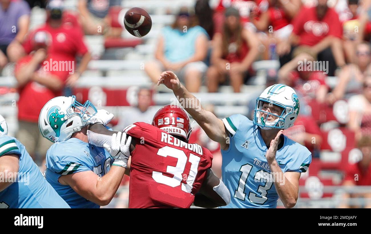 Tulane quarterback Justin Ibieta (13) passes the ball against Oklahoma
