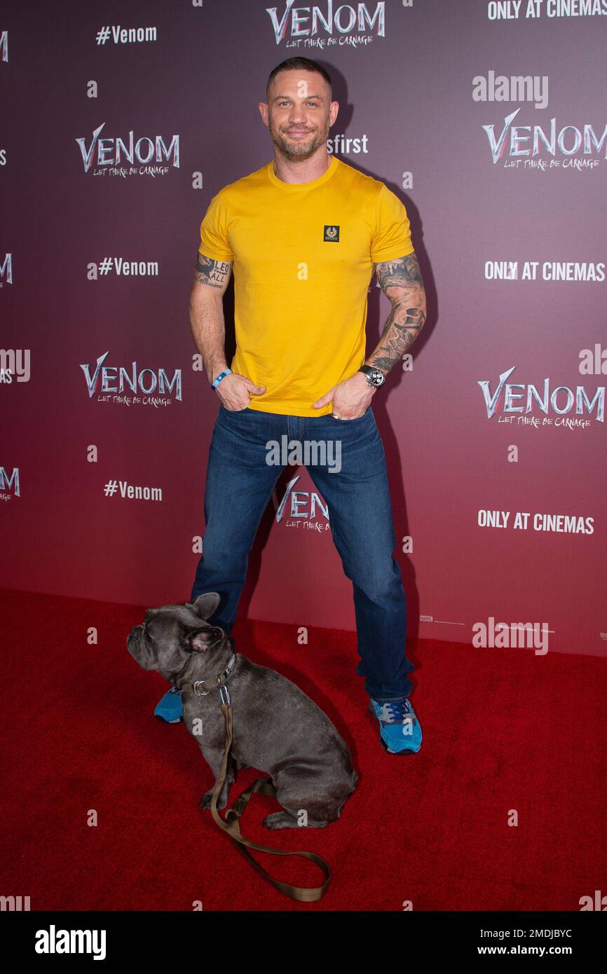 Tom Hardy poses for photographers, with his dog Blue, during a photo
