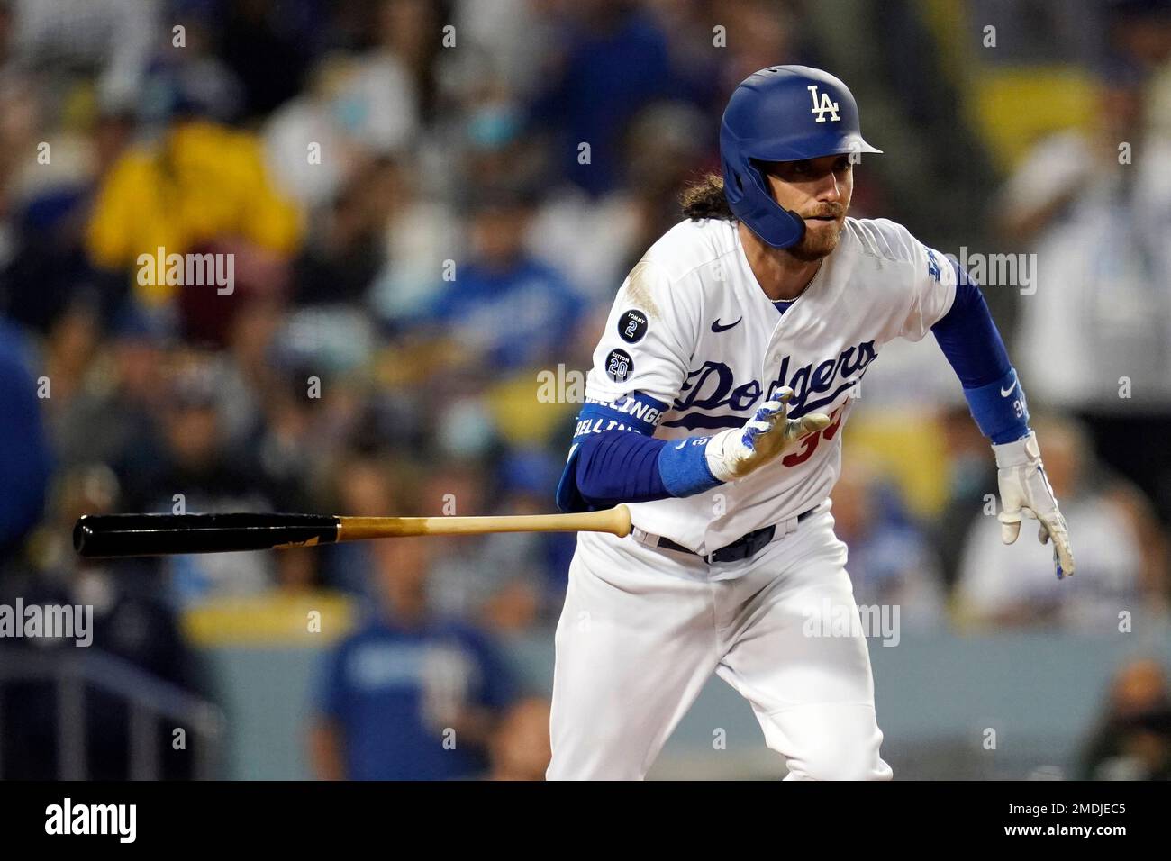 Los Angeles Dodgers' Cody Bellinger drops his bat as he doubles during