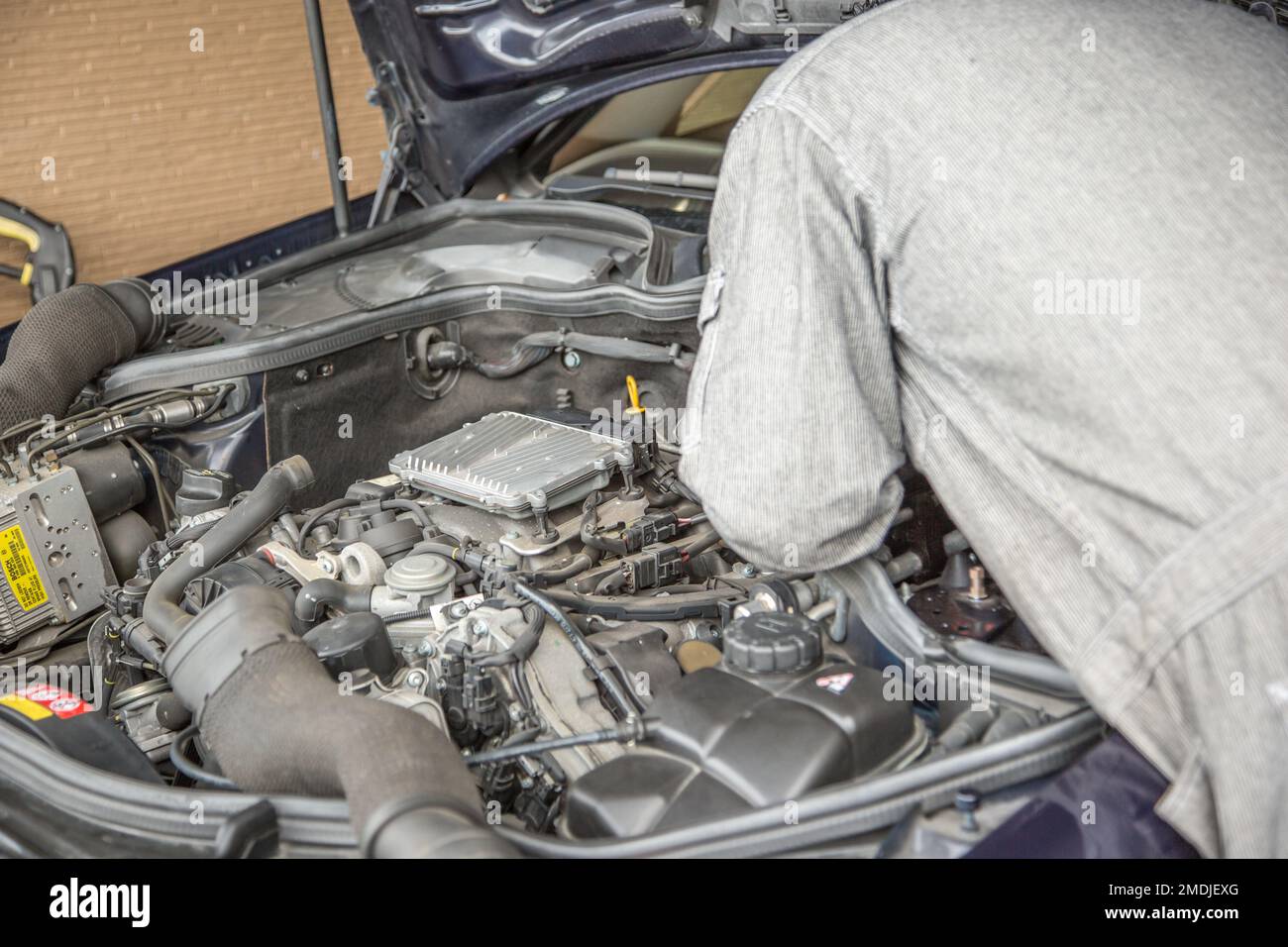 Shooting the moment when an auto mechanic replaces parts Stock Photo