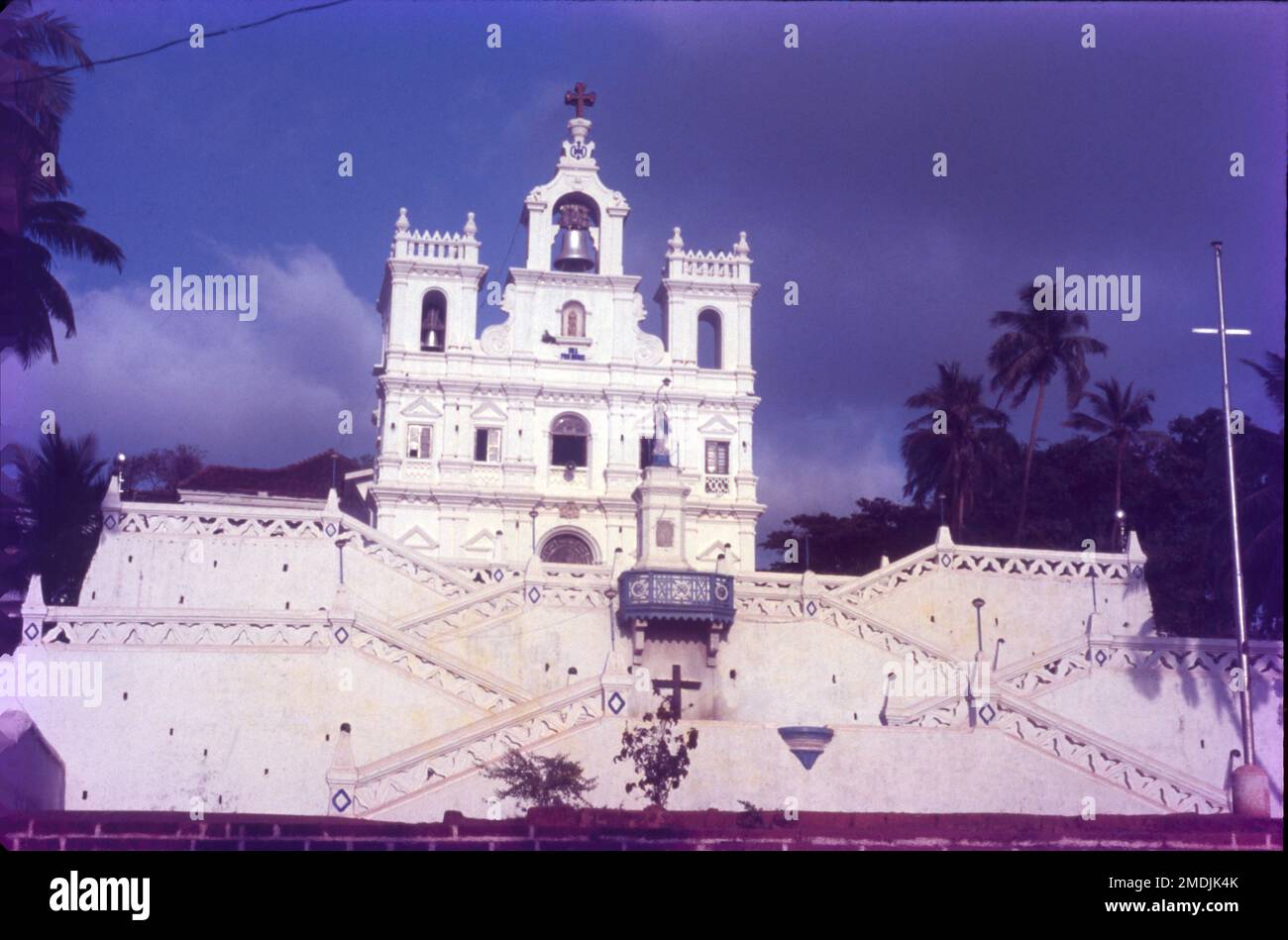 The Our Lady of the Immaculate Conception Church is located in Panjim, Goa, India. The colonial Portuguese Baroque style church was first built in 1541 as a chapel on a hill side overlooking the city of Panjim. The white sparkling church is majorly famed for its architecture and its flight of stairs that zigzag to the top. Another attraction of the church is the Augustinian Bell located in the belfry, which also the second largest bell in Goa. Built in a Portuguese Baroque style, the church is located on a slight elevation, on a hillock. Stock Photo