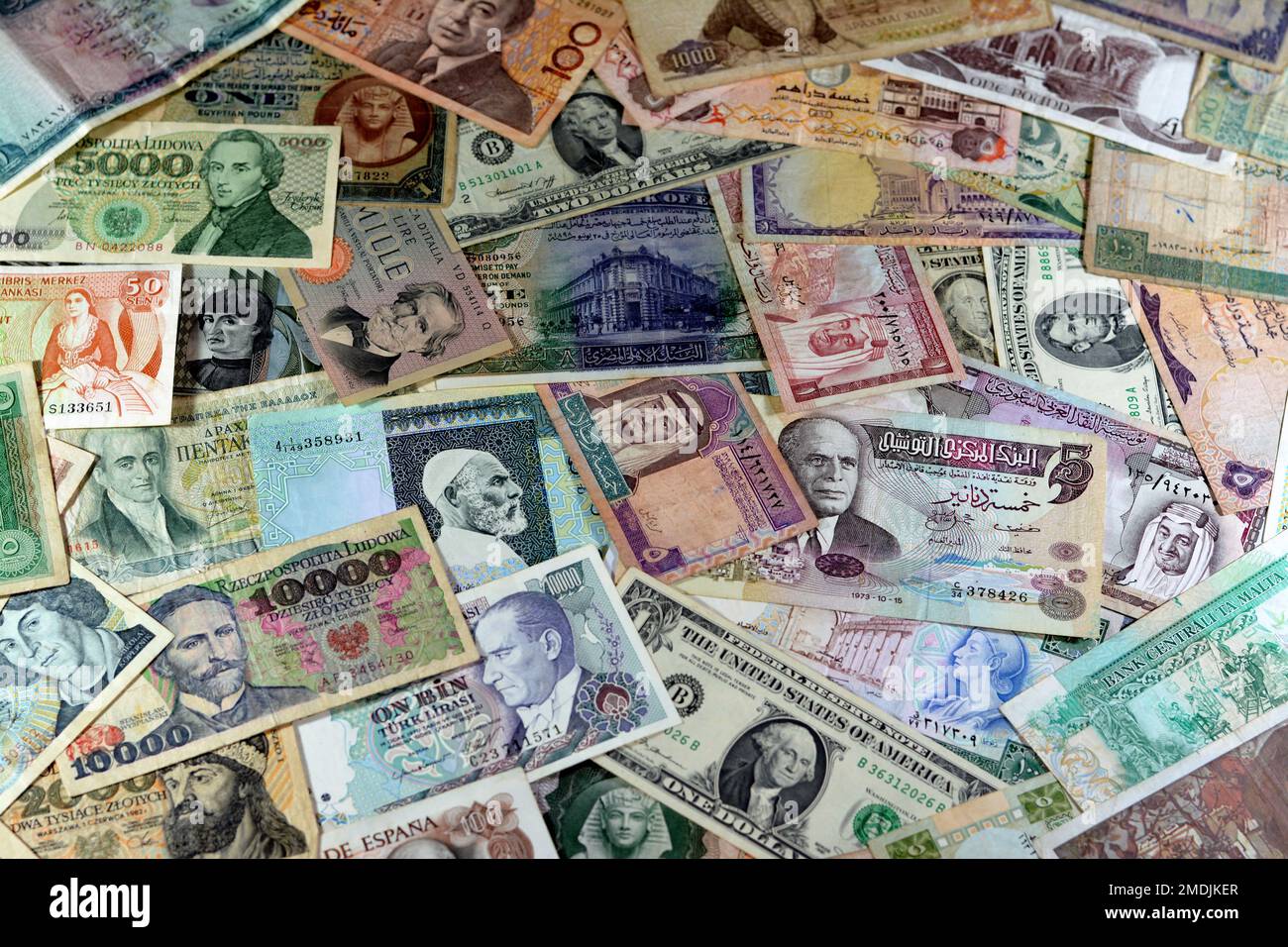 various old cash money banknotes from different countries of the world, stack of multiple currencies, pile of vintage retro bills of different origins Stock Photo