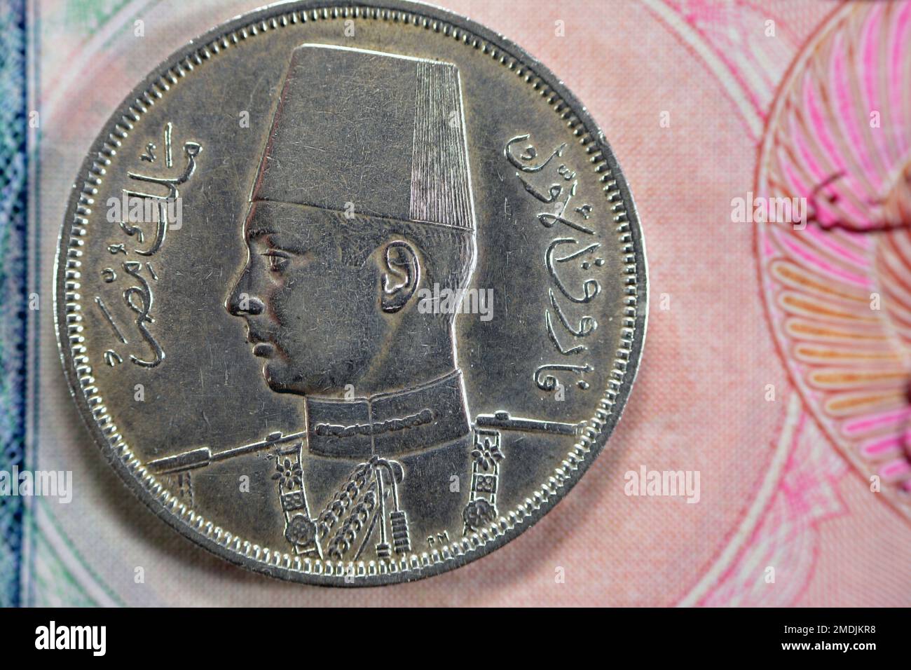 Ancient old ten 10 Egyptian piasters coin at the era of king Farouk I features value and kingdom of Egypt on a side and a bust of King Farouk the 1st Stock Photo