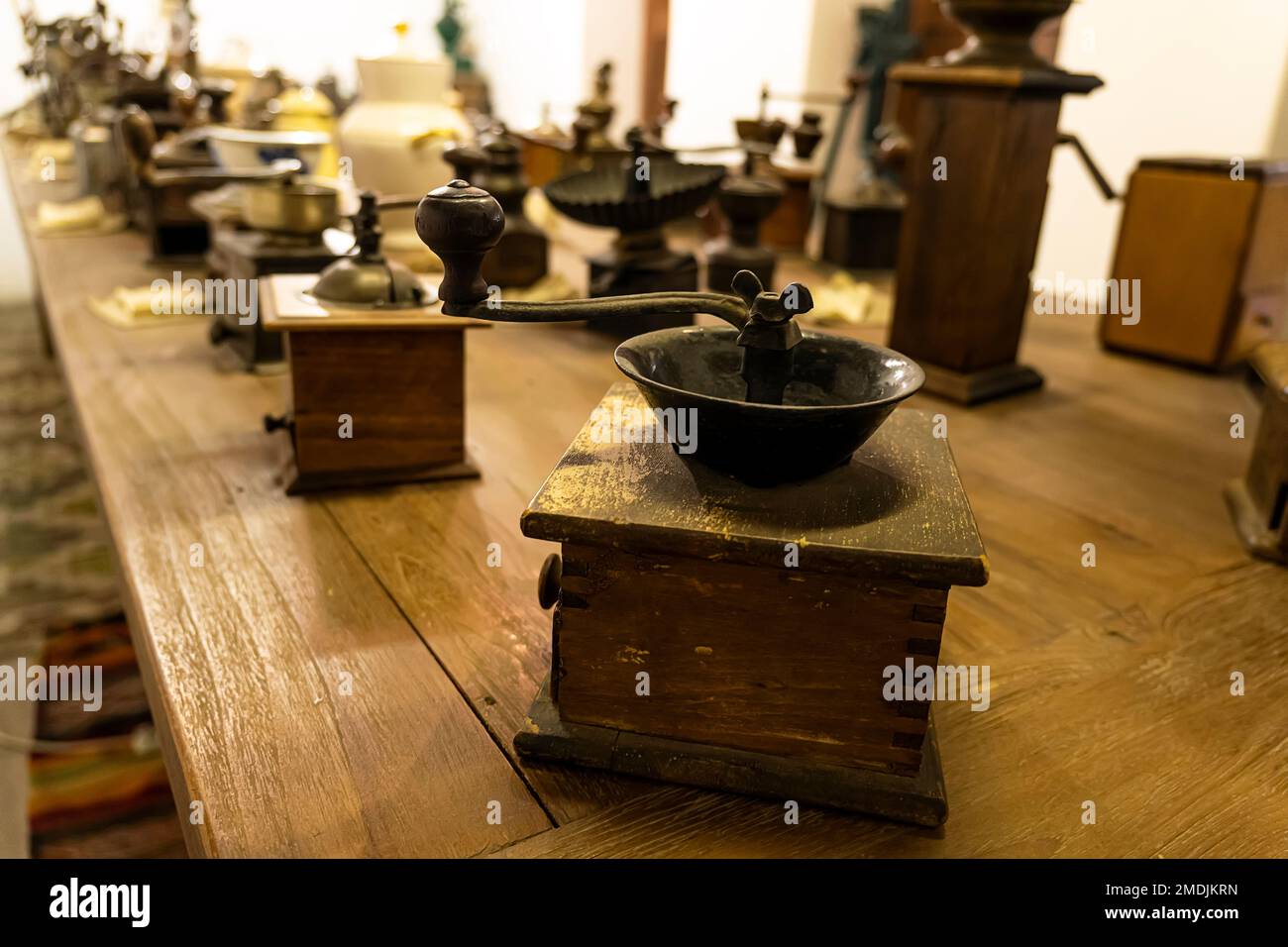 a lot of old antique various coffee grinders from different countries