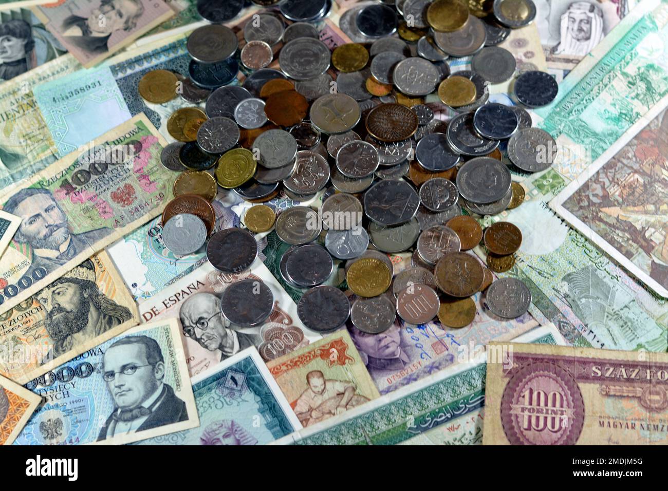 Old coins on various old cash money banknotes from different countries