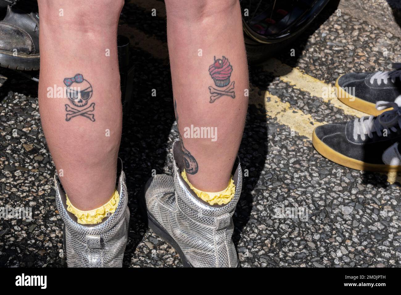 Tattoos on the calves of legs. Stock Photo