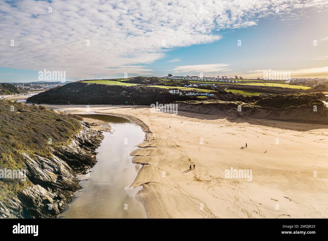 The Gannel River flowing to the sea across Crantock Beach on the coast of Newquay in Cornwall in the UK. Stock Photo