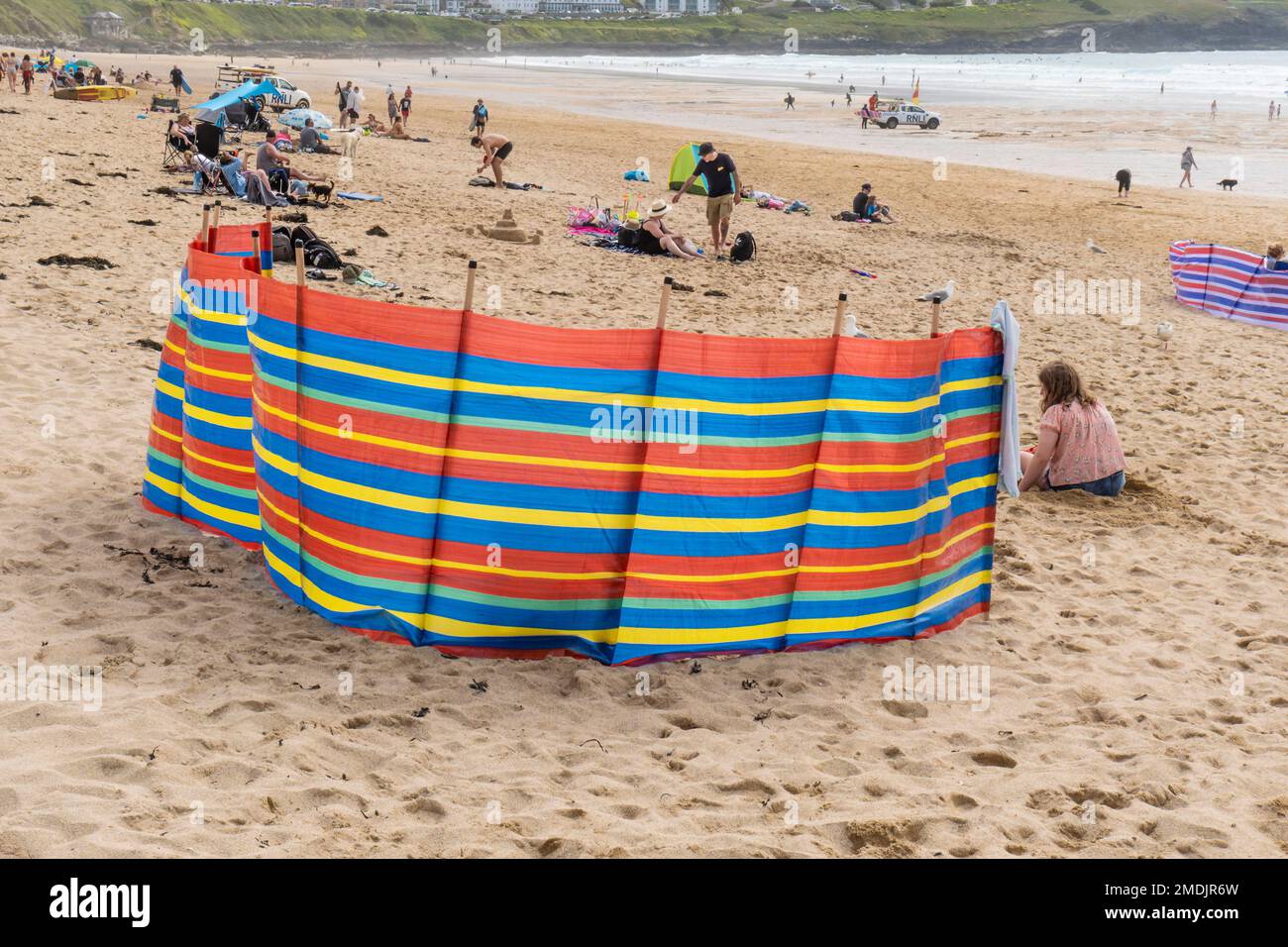 Colourful Colorful windbreaks on Fistral Beach in Newquay in Cornwall in the UK. Stock Photo