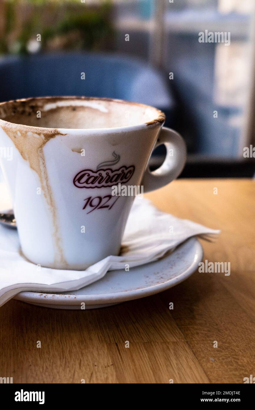 A used cappuccino coffee cup on a table in a restaurant. Stock Photo