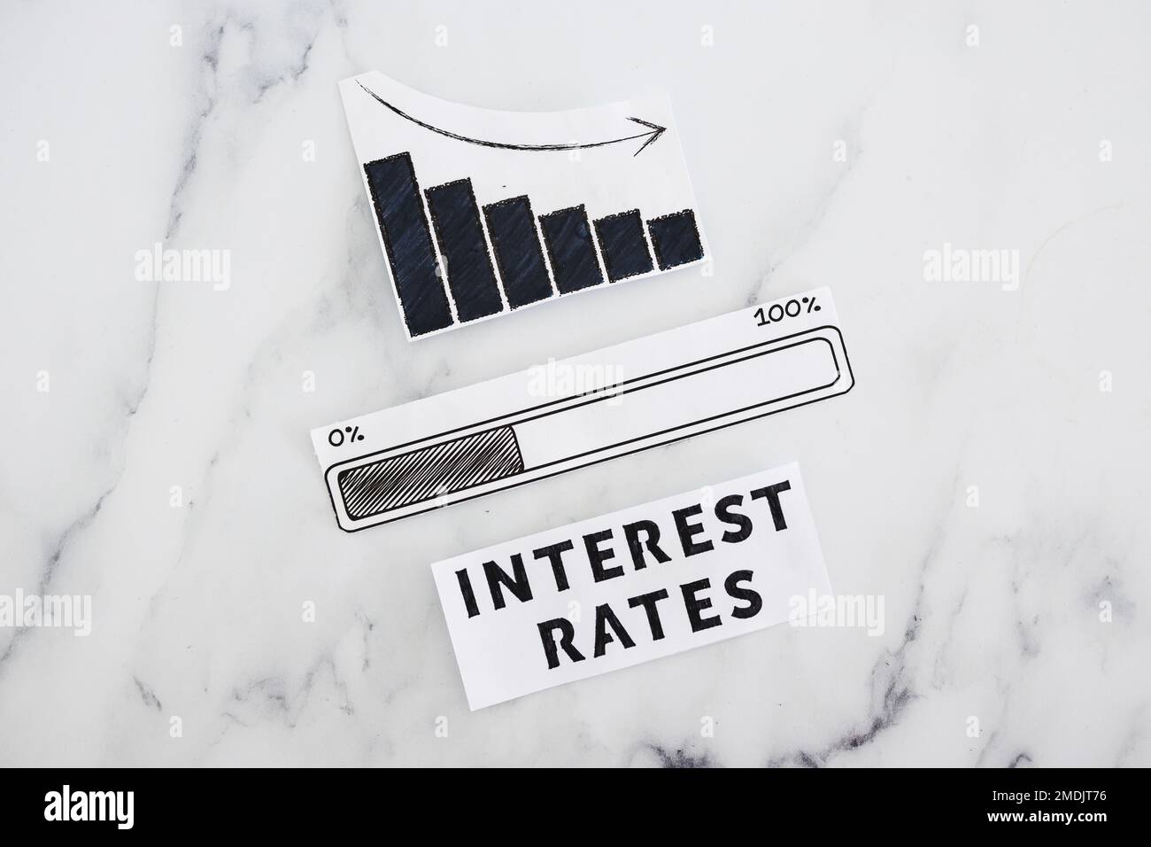 interest rates going down, text with graph showing stats decreasing and progress bar loading underneath Stock Photo