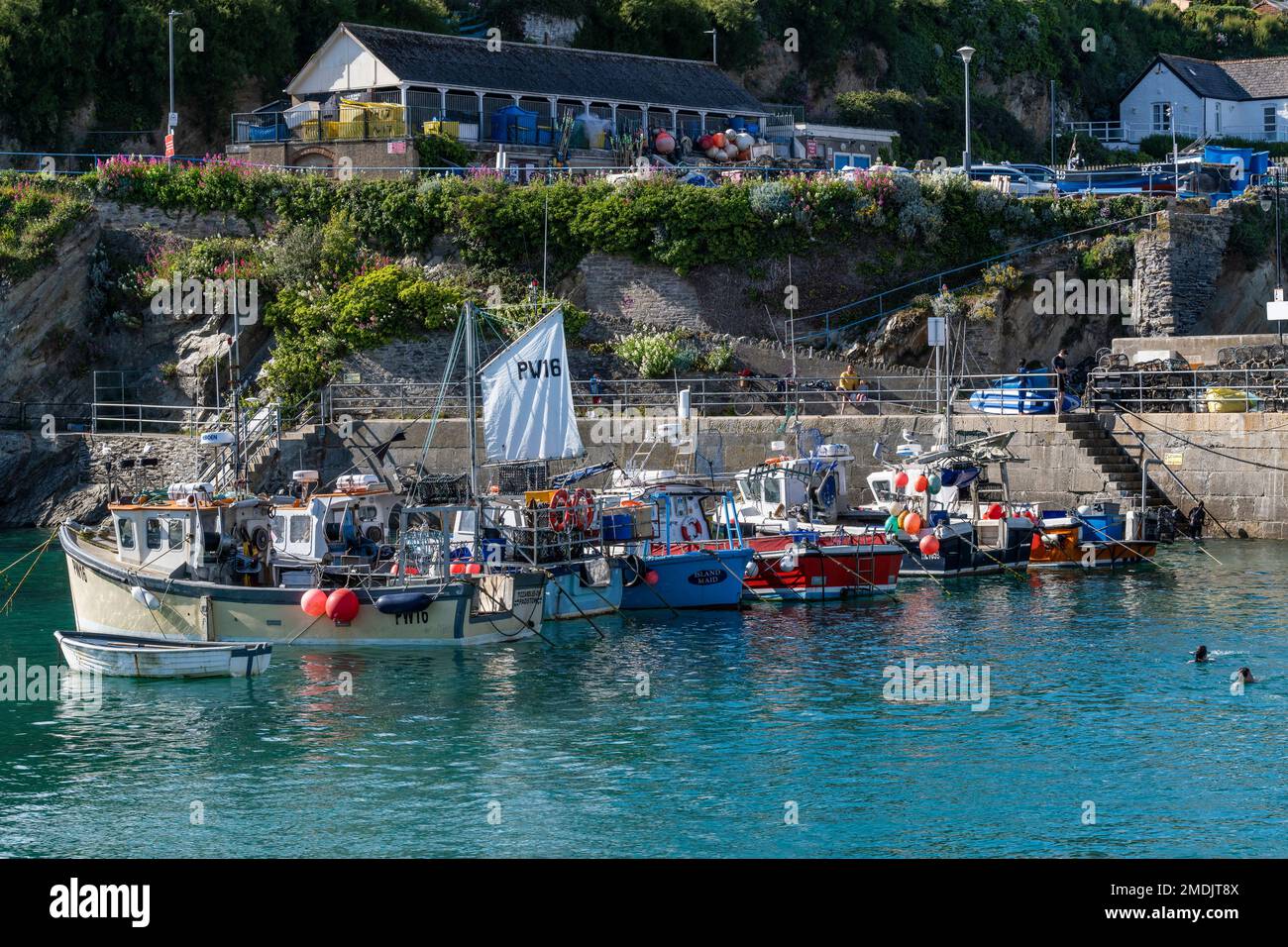 Fishing boats moored in the picturesque Newquay Harbour in Cornwall in the UK. Stock Photo