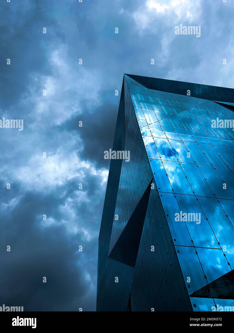 A low-angle vertical shot of a modern architectural building under a ...