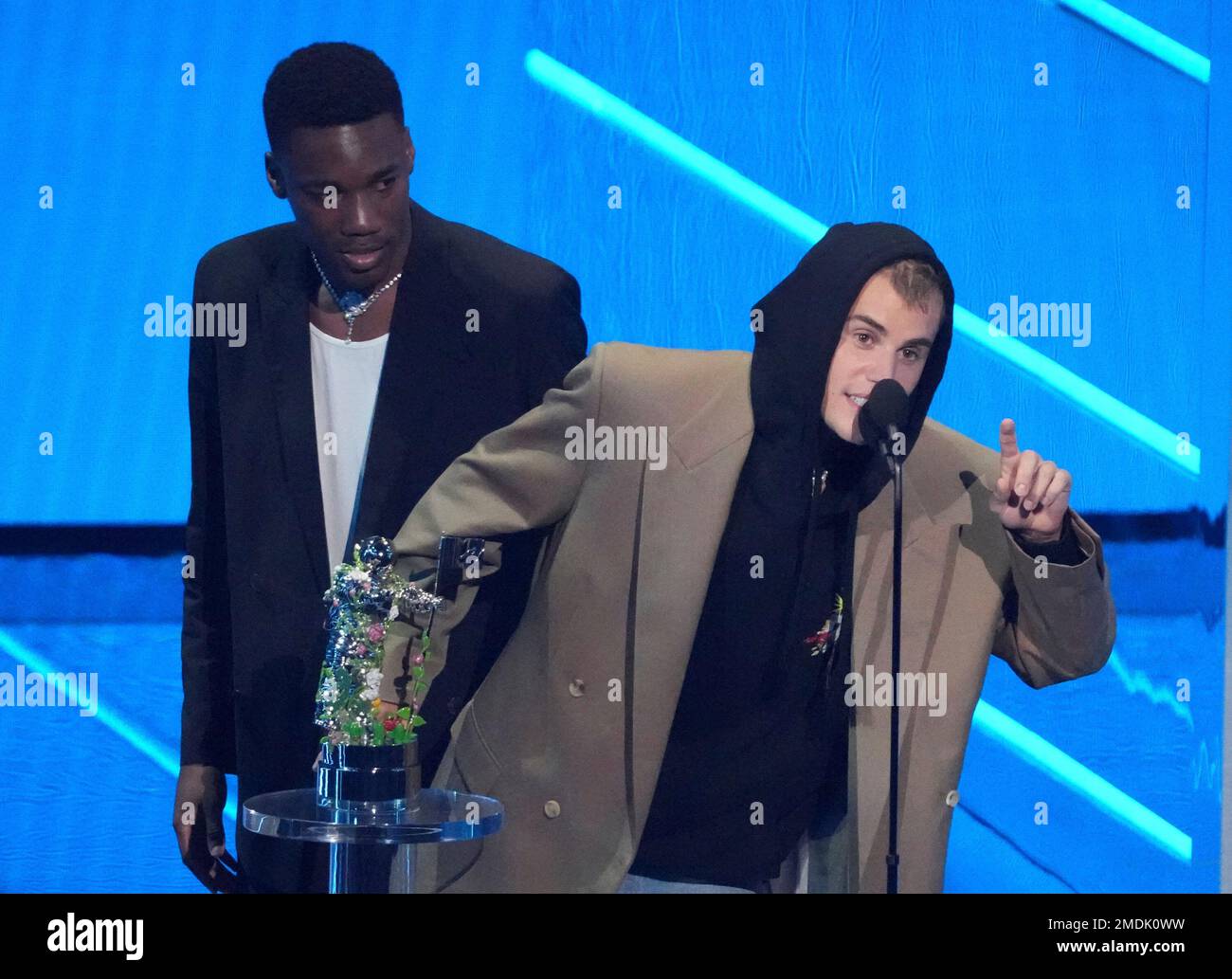Justin Bieber, right, and Giveon accept the award for best pop song for