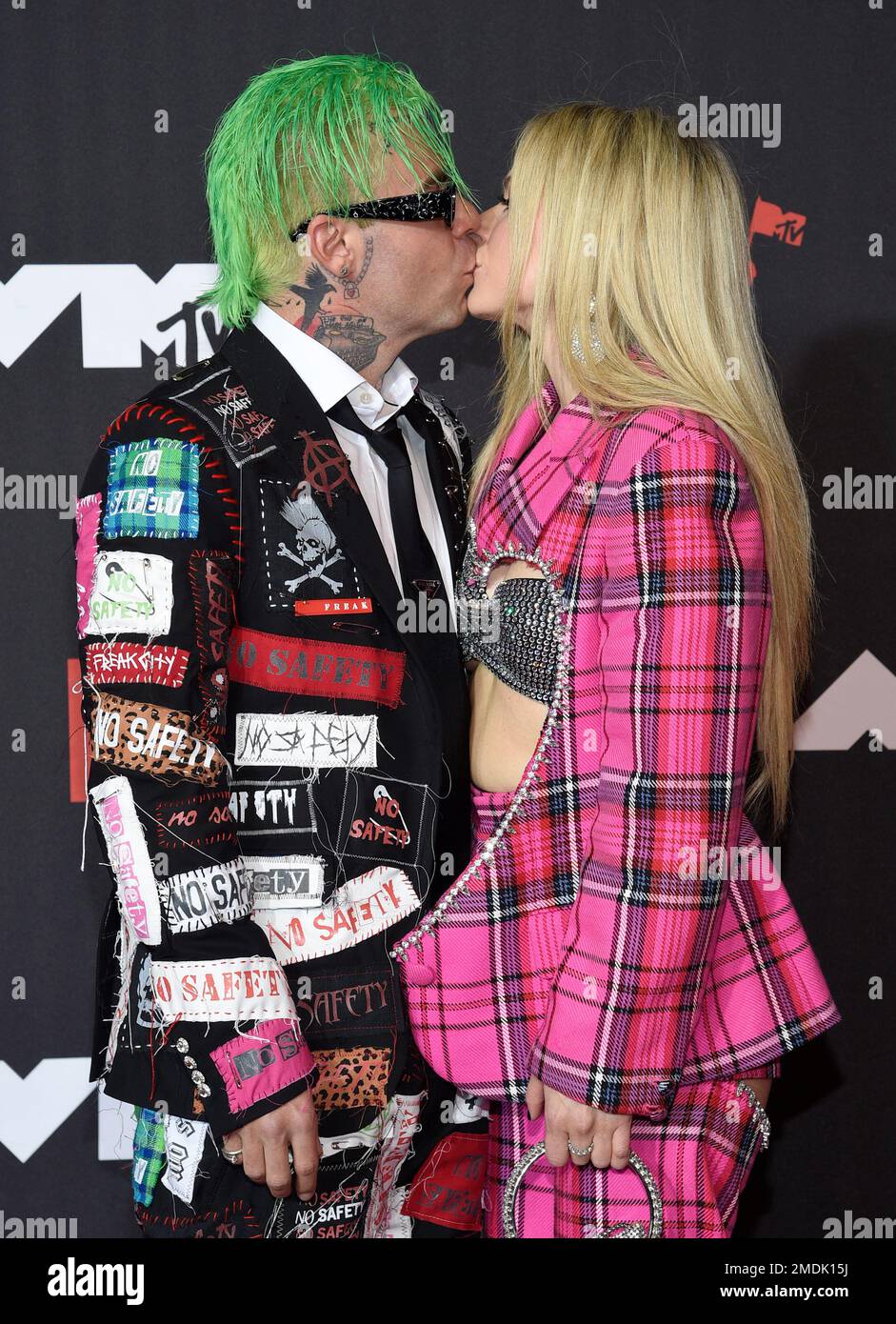 Mod Sun, left, and Avril Lavigne kiss as they arrive at the MTV Video