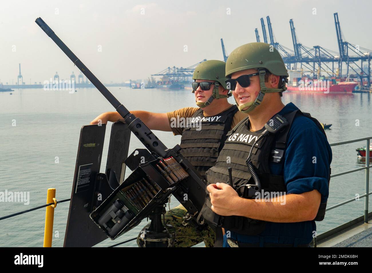 JAKARTA, Indonesia (July 25, 2022) Torpedoman 2nd Class Colin Williams, left, from Lemars, Iowa, and Torpedoman 1st Class Robert Hollister, right, from Camarillo, California, both assigned to the Emory S. Land-class submarine tender USS Frank Cable (AS 40), man an M2A1 .50 caliber machine gun as the ship departs Jakarta, Indonesia, July 25, 2022. Frank Cable is currently on patrol conducting expeditionary maintenance and logistics in support a free and open Indo-Pacific in the U.S. 7th Fleet area of operations. Stock Photo