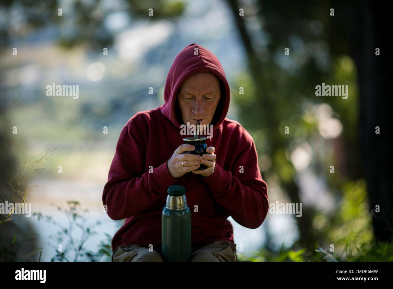 A man drinks mate by a Mate cup in the Park. Stock Photo