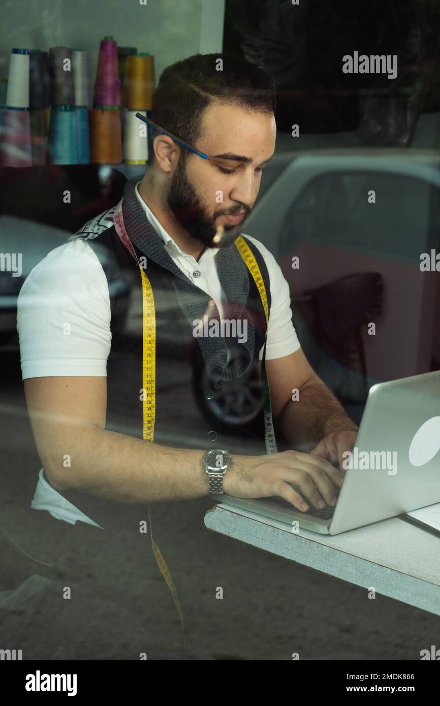 Tailor man working at his atelier Stock Photo
