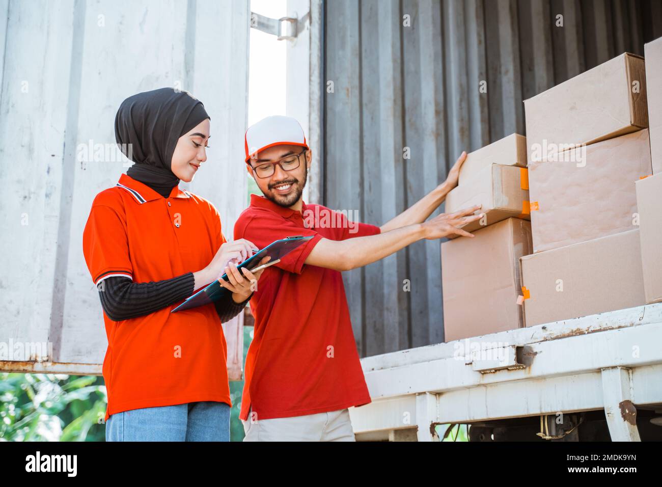 two forwarders checking boxes of shipping packages in a cargo Stock