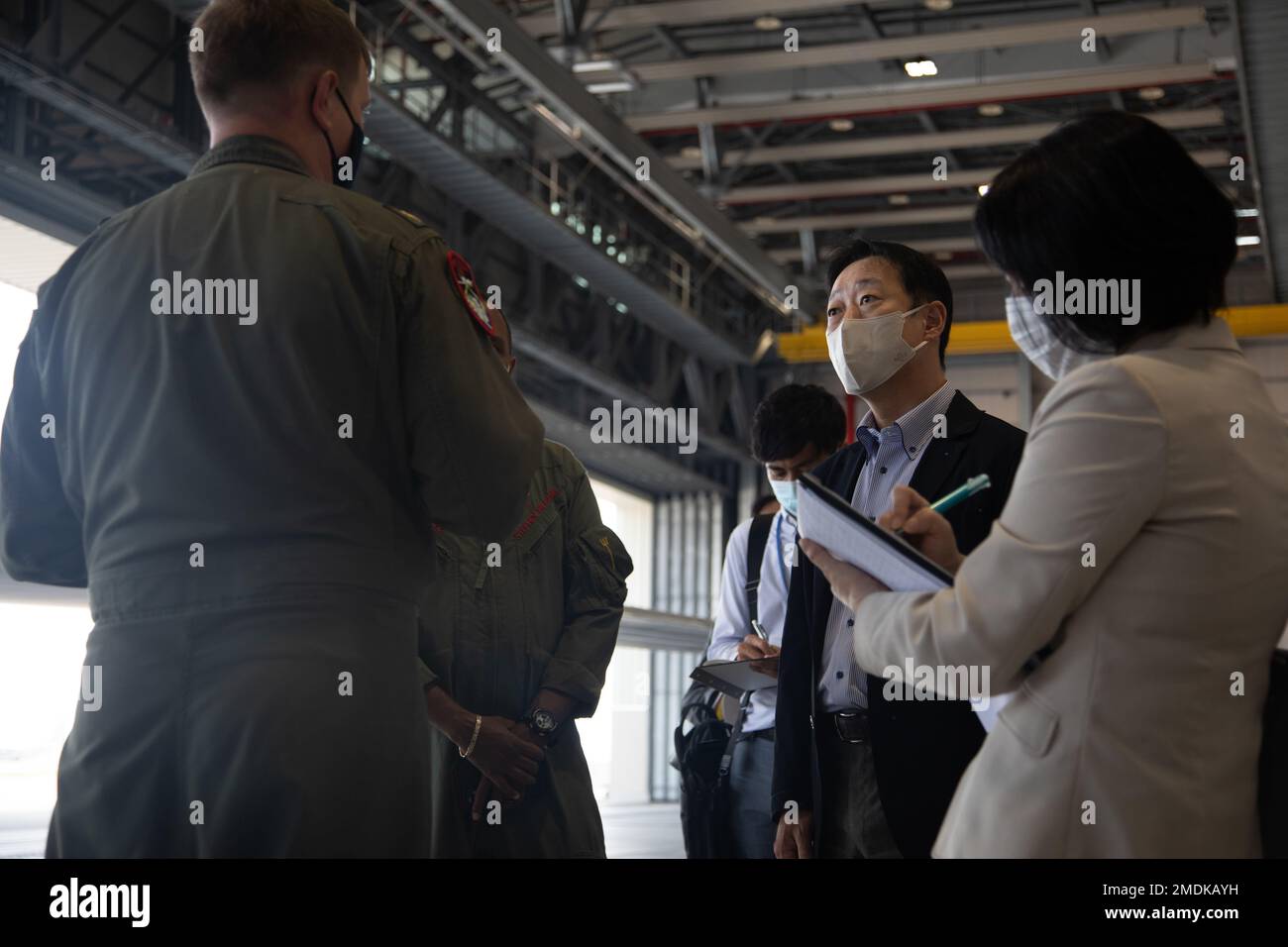 U.S. Navy Cmdr. Stephen Williams, Commander of Unmanned Patrol Squadron (VUP) 19, and Lt. Cmdr. Casey Powell, attached to Unmanned Patrol Squadron (VUP) 19, give Yoshihiko Fukuda, Mayor of Iwakuni city a brief at Marine Corps Air Station Iwakuni, on July 25, 2022. The purpose of the visit was to discuss the importance and functionalities of the Northtrop Grumman MQ-4C Triton and its recent arrival to MCAS Iwakuni. Stock Photo