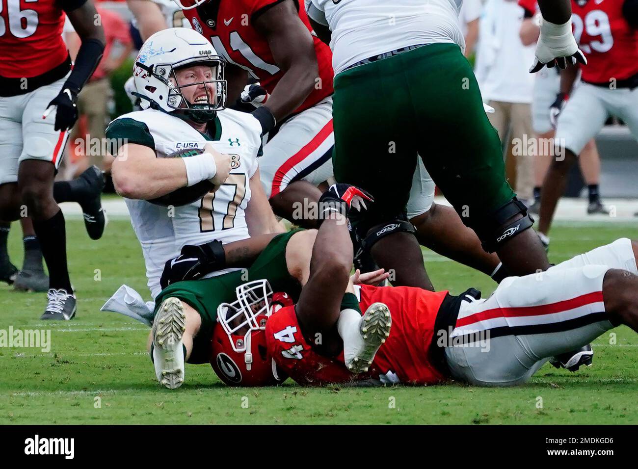 UAB quarterback Tyler Johnston III (17) is brought down by Georgia