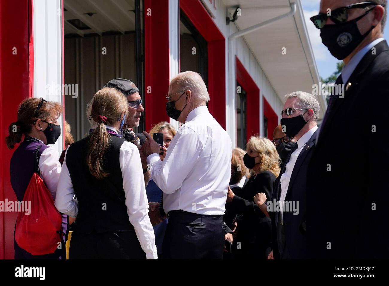 President Joe Biden and first lady Jill Biden speak to people as they
