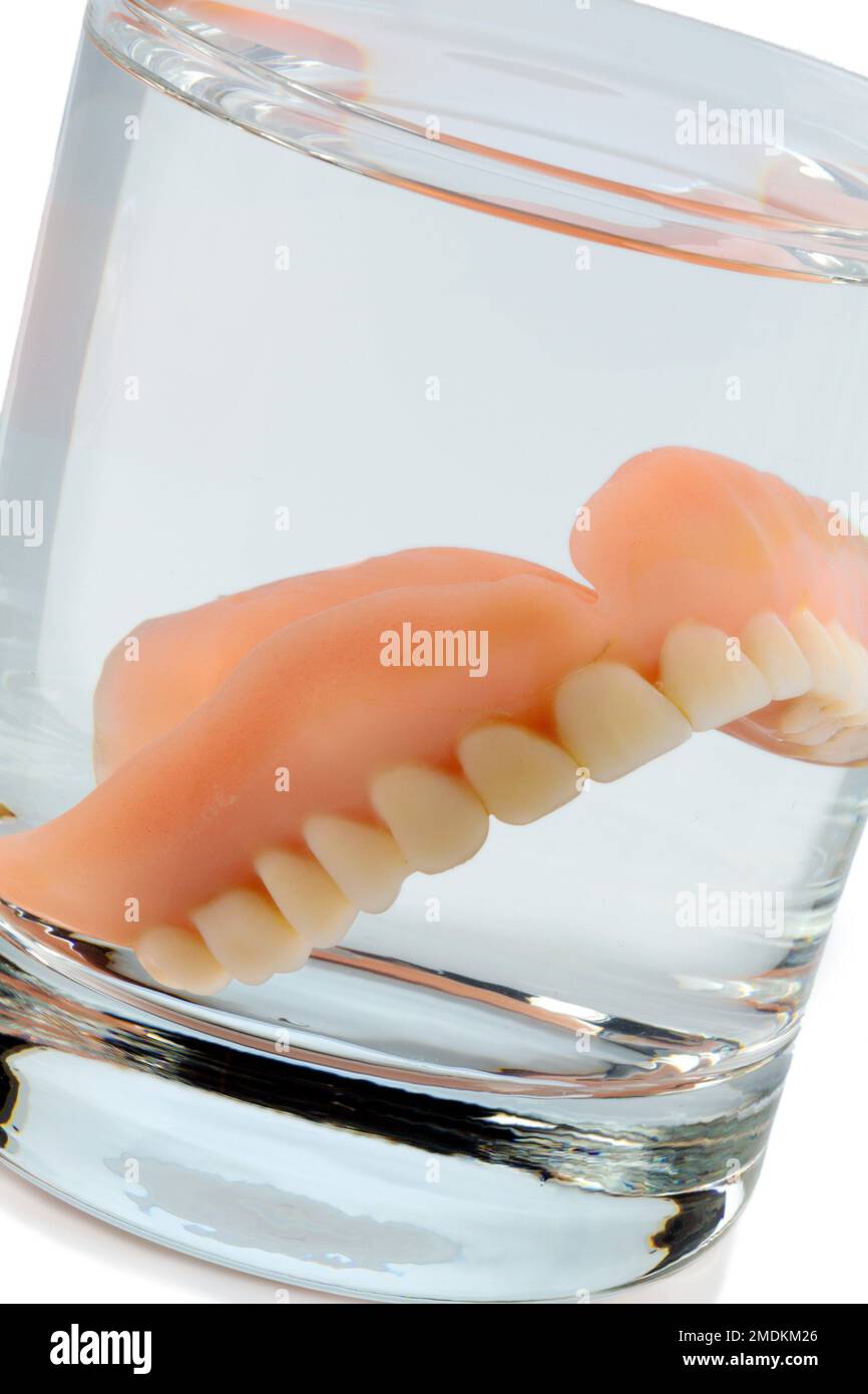 dental prosthesis in a water glass Stock Photo Alamy