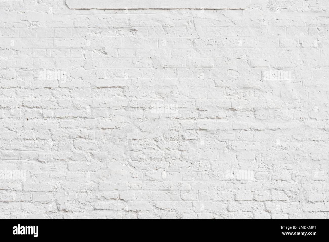 Old plaster wall painted in white with brick pattern as background Stock Photo