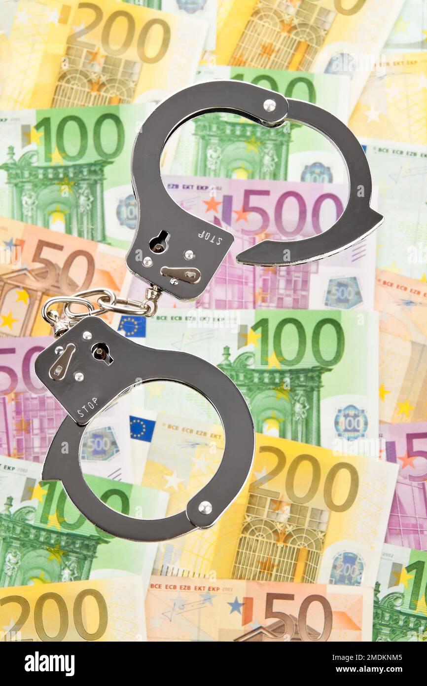 Euro bills with handcuffs Stock Photo