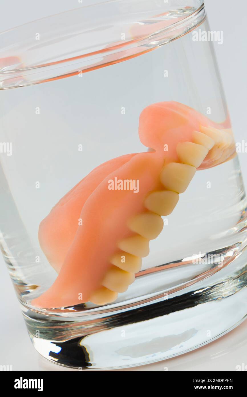 dental prosthesis in a water glass Stock Photo Alamy