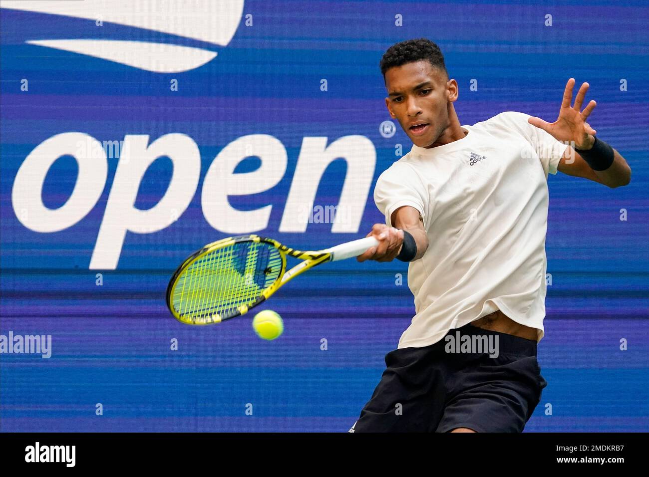 Felix Auger-Aliassime, of Canada, returns a shot to Daniil Medvedev, of Russia, during the semifinals of the US Open tennis championships, Friday, Sept