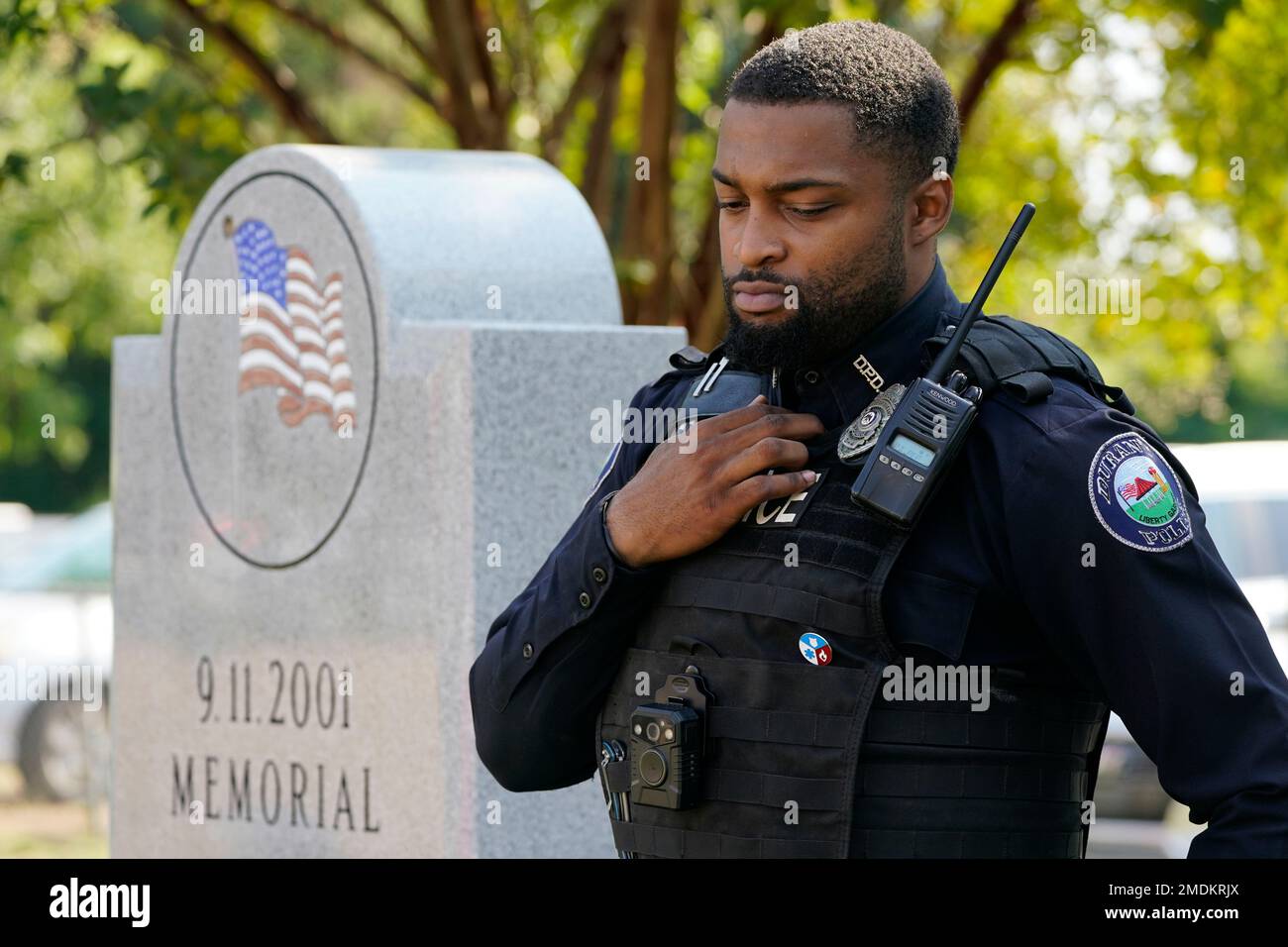 Durant police officer Cedric Common, bows his head during the